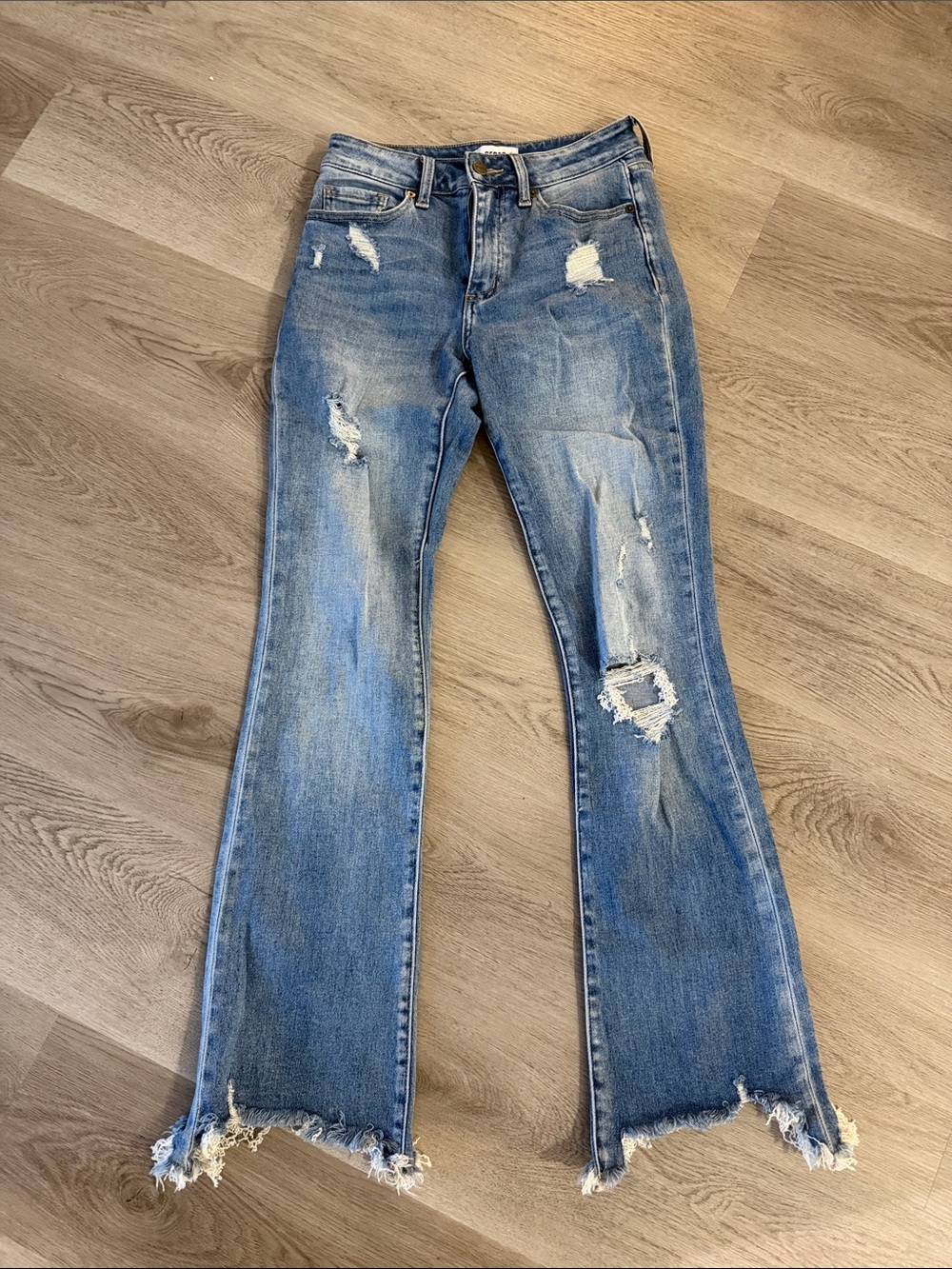 Distressed Light Blue Flare Jeans with Raw Hem